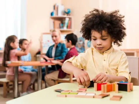 a young boy sitting at a table