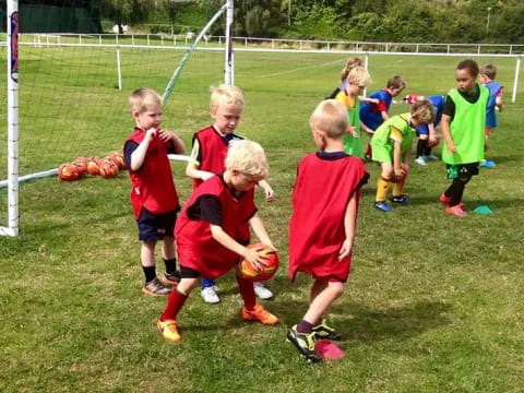 a group of kids playing football