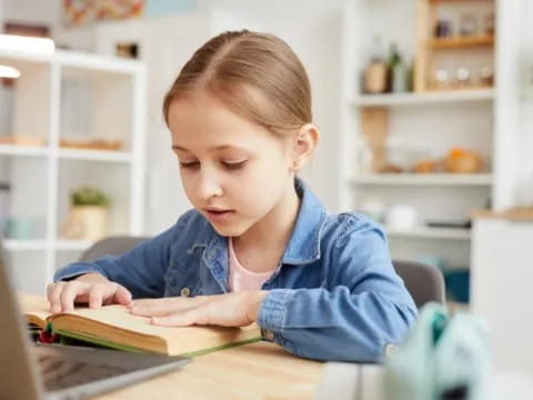 a young girl reading a book