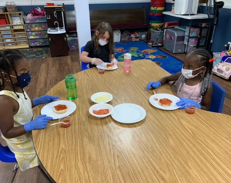 a group of girls eating at a table