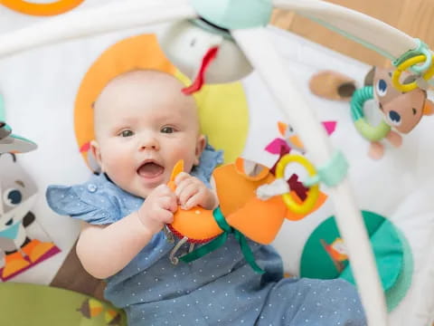 a baby in a highchair with a toy