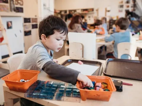 a young boy playing with a toy