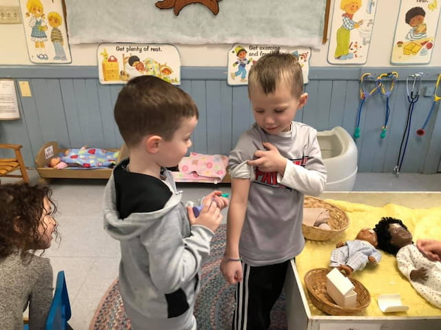a couple of young boys in a classroom