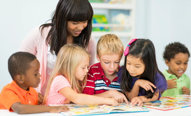 a person and several children looking at a map