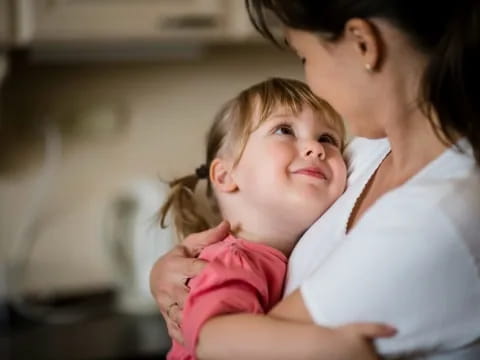 a woman holding a baby