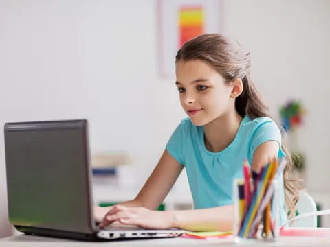 a young girl using a laptop
