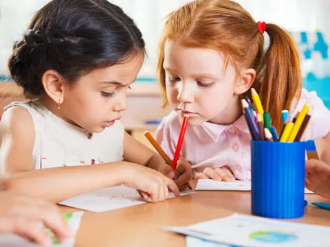 a few young girls coloring