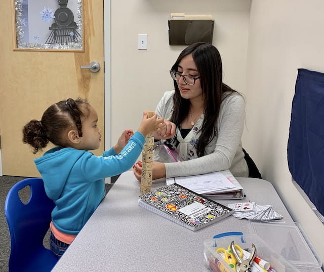 a woman and a child sitting at a table