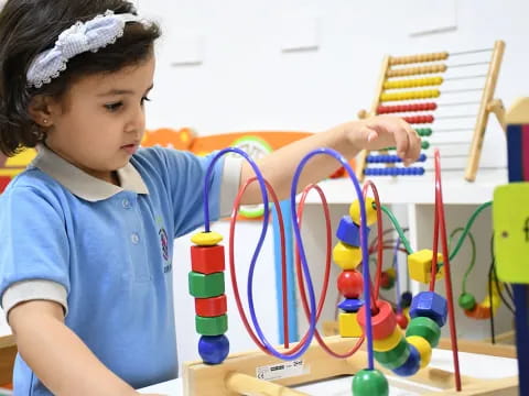 a young girl playing with a toy