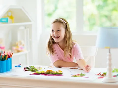 a girl sitting at a table