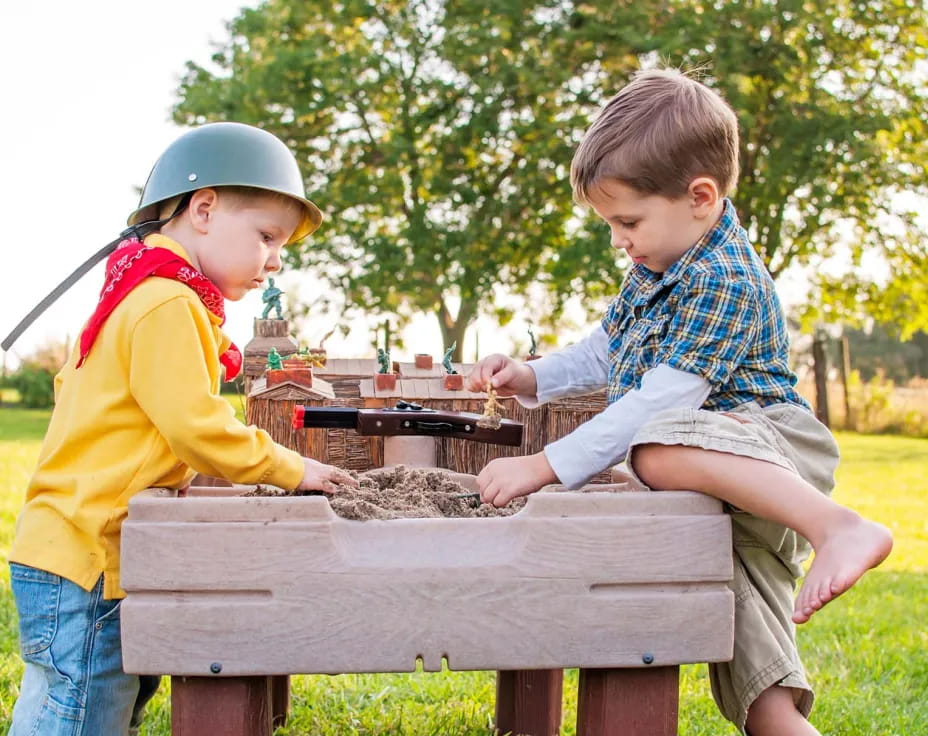 two boys playing with a toy