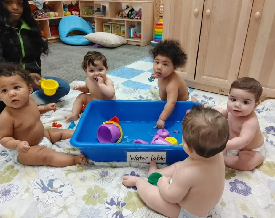 a group of kids playing in a pool