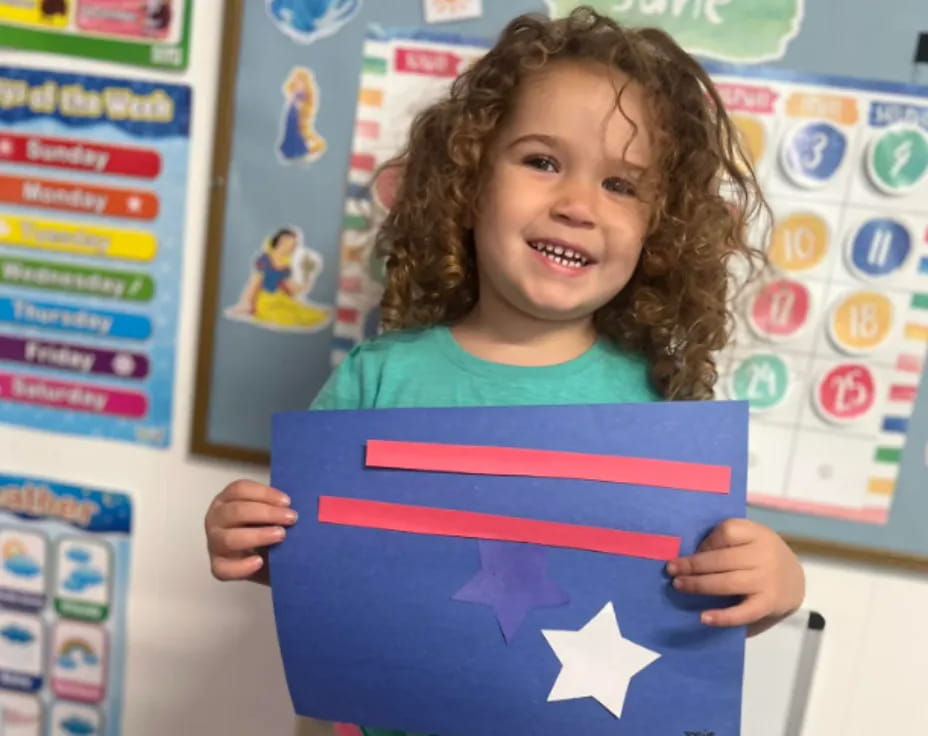 a child holding a flag