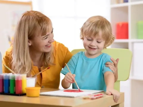 a person and a child painting