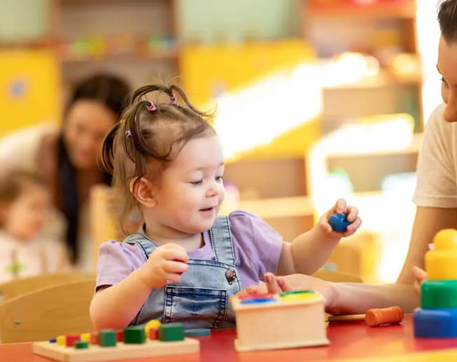 a young girl playing with a toy