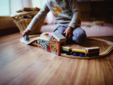 a child playing with a toy train