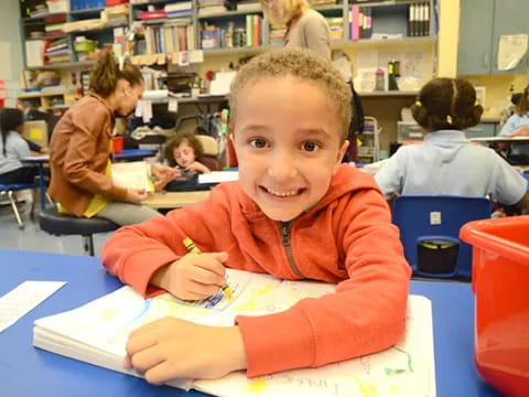 a boy sitting at a desk
