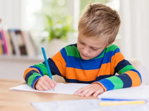 a child writing on a book