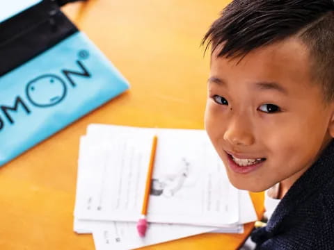 a boy sitting at a desk