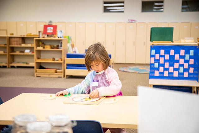 a child sitting at a table