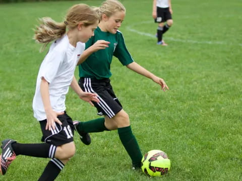 girls playing football on a field