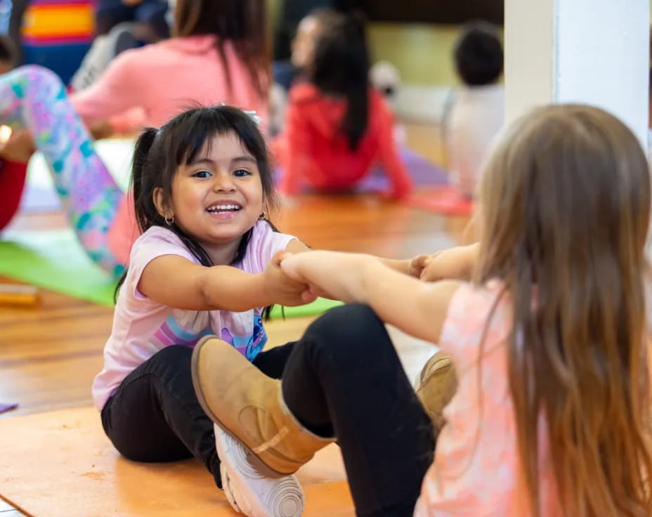 a young girl sitting on the floor
