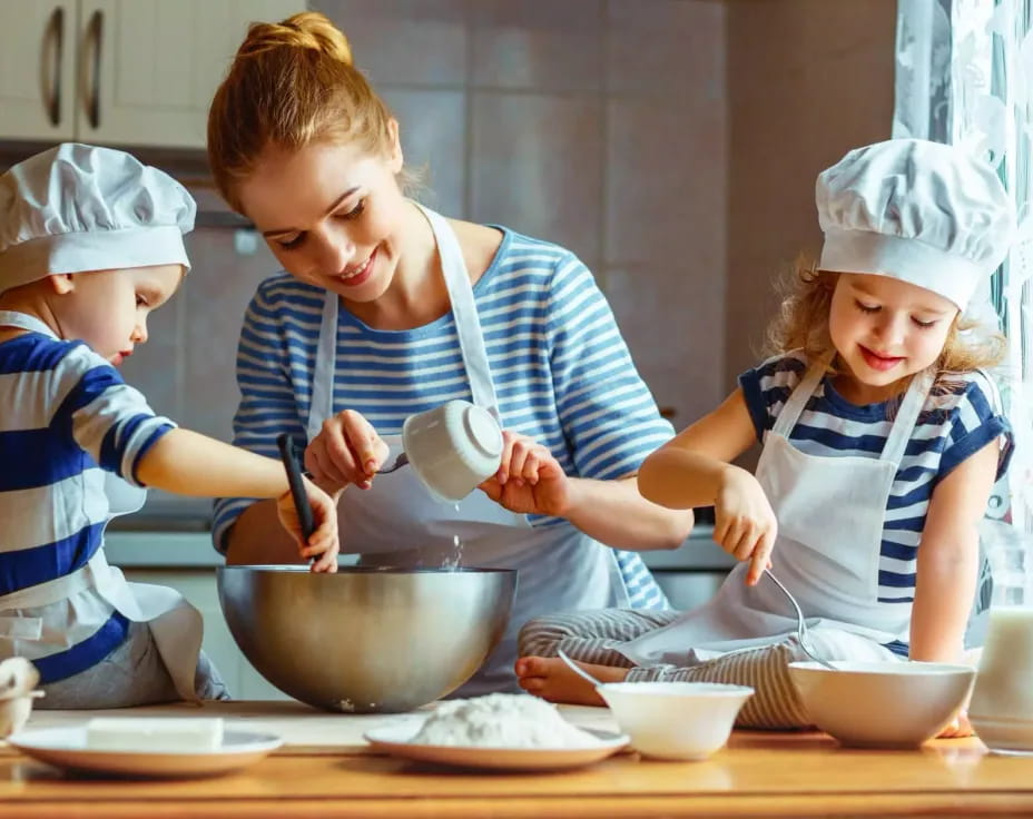 a person and two children cooking