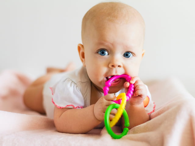 a baby holding a toy