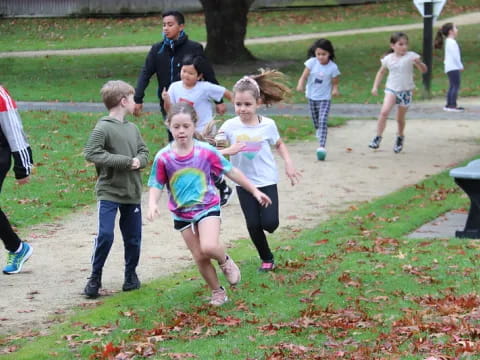 a group of children running on a path