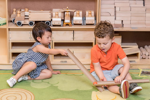 a couple of kids playing with a toy