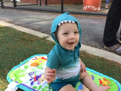 a baby sitting on a blanket