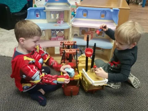 two boys playing with toys