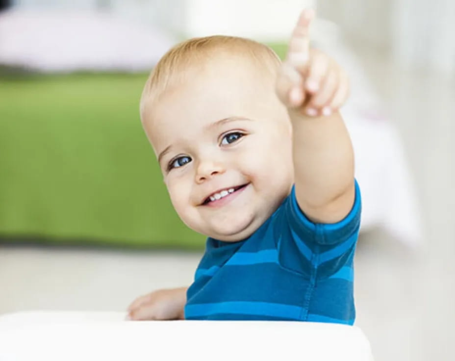 a baby with a thumbs up