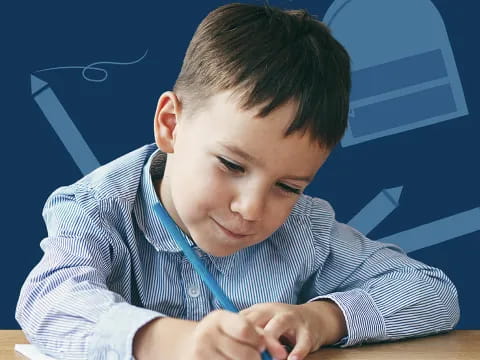 a young boy sitting at a desk