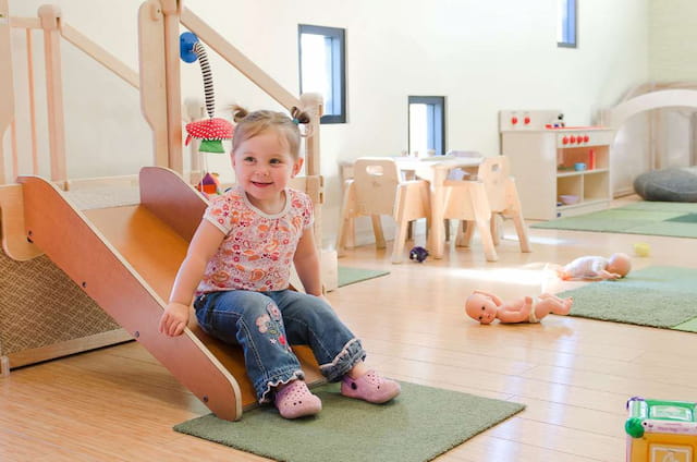 a girl sitting on a mat