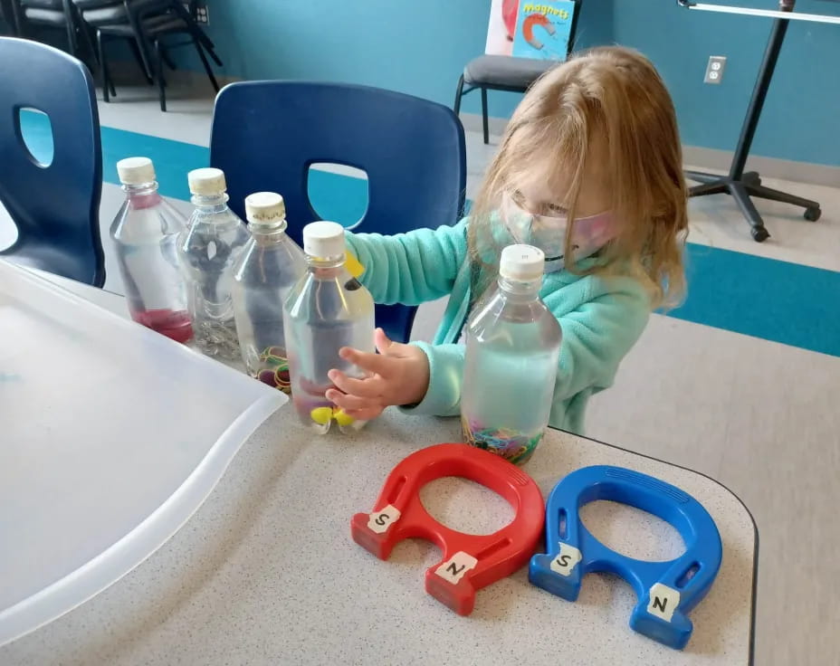 a girl playing with toys