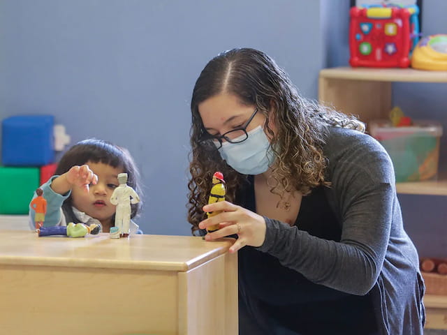 a woman holding a toy