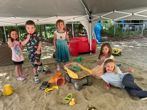 a group of children in a tent
