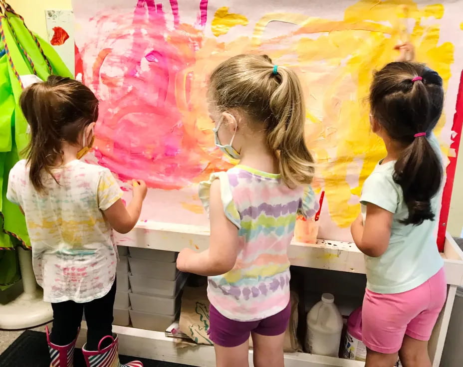 a group of young girls painting