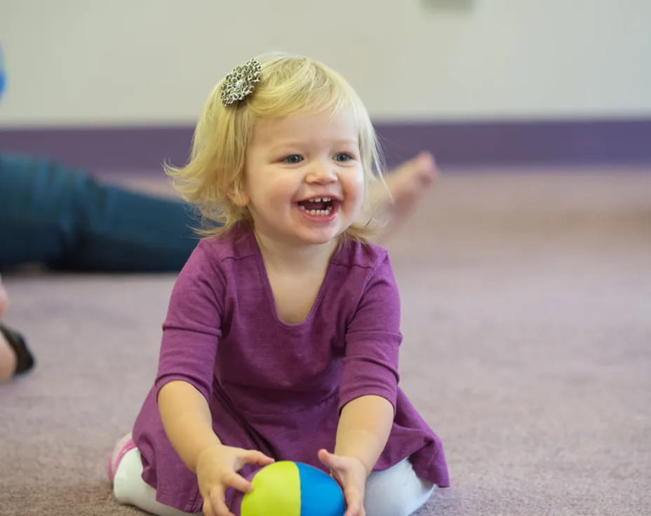 a little girl sitting on the floor
