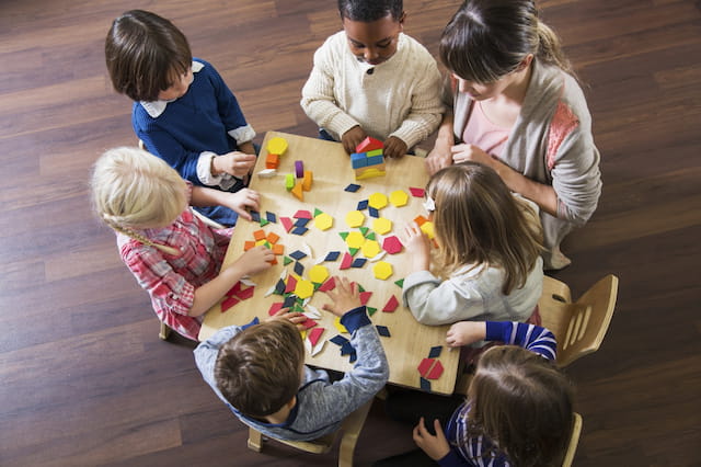 a group of children playing with a puzzle