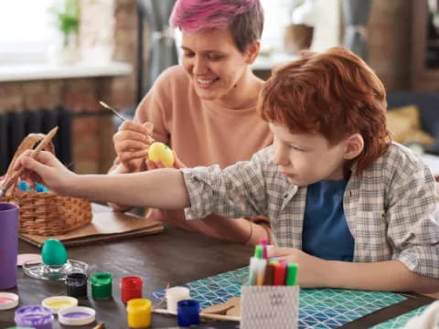 a person and a boy painting