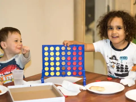 a couple of kids eating at a table
