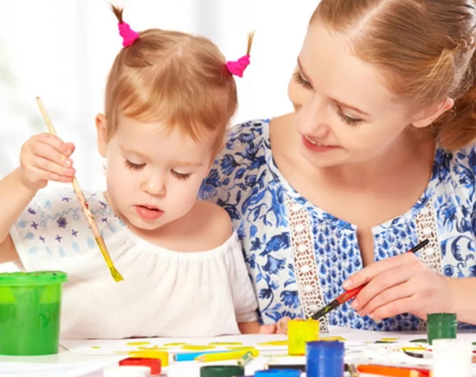 a person and a child painting