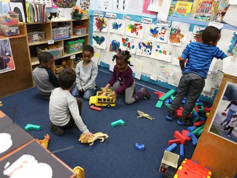 a group of children playing with toys