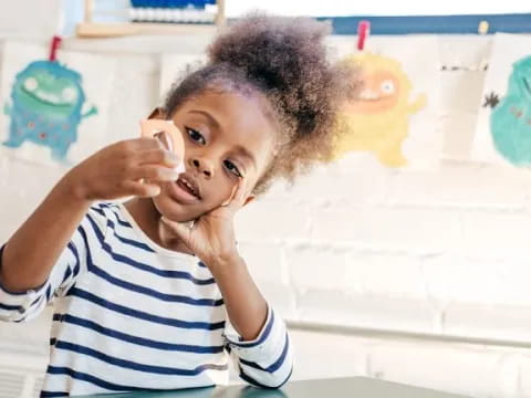 a child holding a bottle