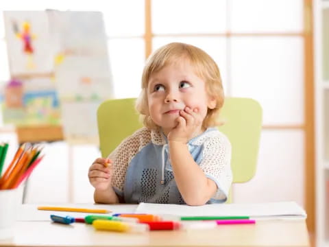 a child sitting at a table