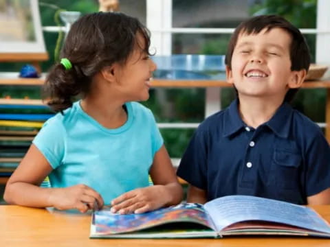 a boy and girl reading a book