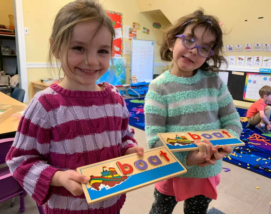 a couple of children holding a toy