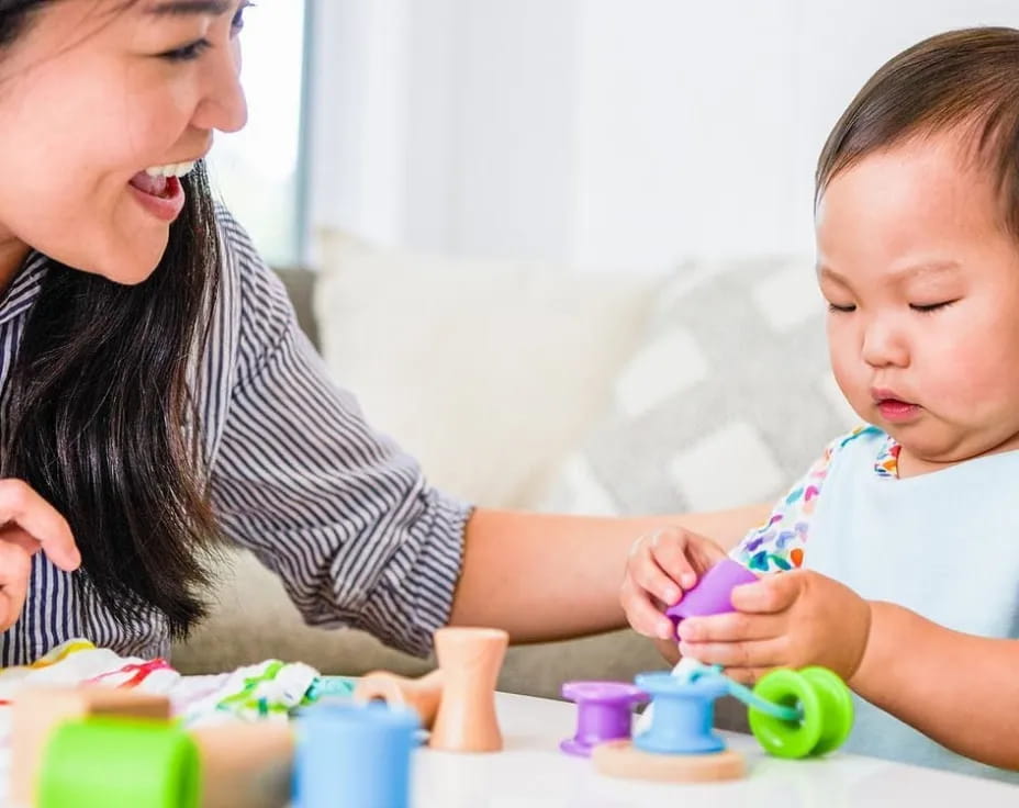 a person and a child playing with toys